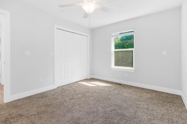 4724 E 135th Ct, Grandview, MO 64030 - unfurnished bedroom featuring carpet, a closet, and a ceiling fan