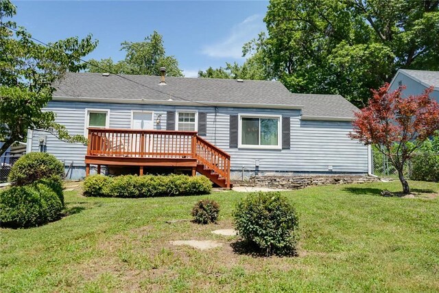 1421 W 28th Ter, Independence, MO 64052 - back of house with a wooden deck, a lawn, and roof with shingles