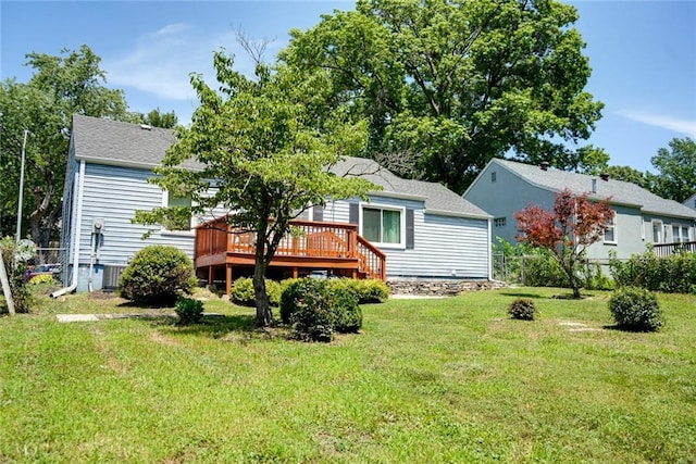 1421 W 28th Ter, Independence, MO 64052 - rear view of property with a deck, a lawn, and a shingled roof