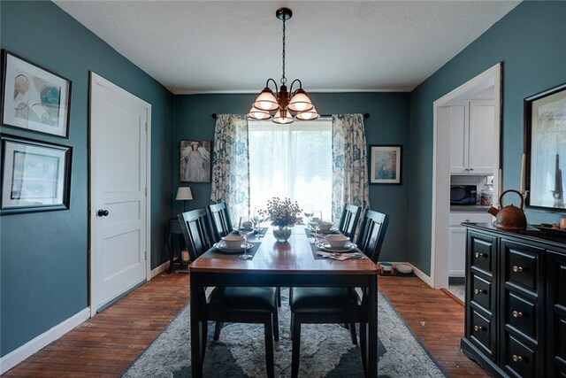 1421 W 28th Ter, Independence, MO 64052 - dining room with a chandelier, dark wood-style flooring, and a textured ceiling