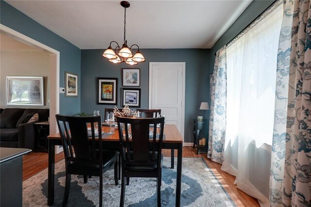 1421 W 28th Ter, Independence, MO 64052 - dining space featuring light wood-style flooring and a chandelier