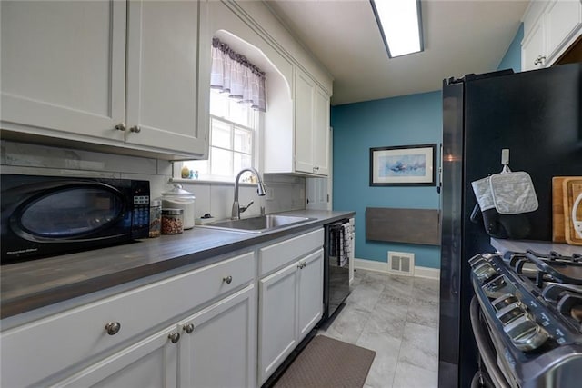 1421 W 28th Ter, Independence, MO 64052 - kitchen with black appliances and white cabinetry