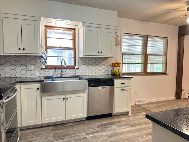 12913 E 41st St S, Independence, MO 64055 - kitchen featuring appliances with stainless steel finishes, dark countertops, backsplash, and ceiling fan