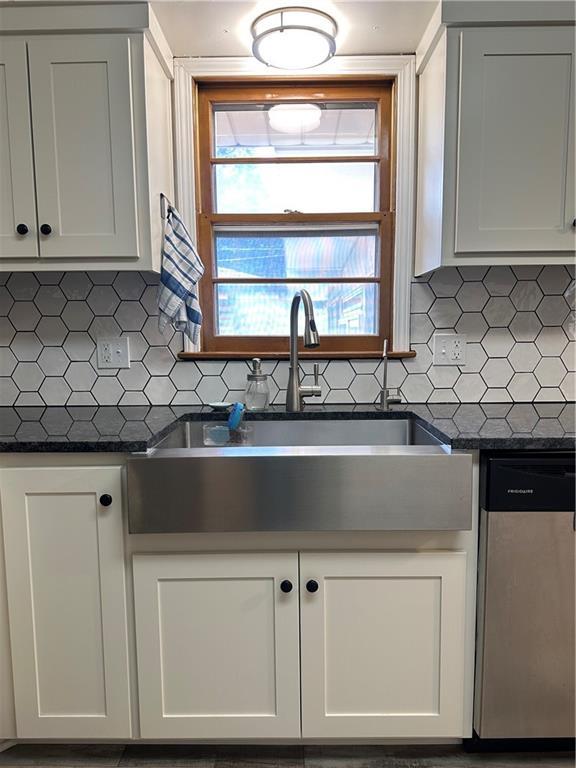12913 E 41st St S, Independence, MO 64055 - kitchen with dishwasher, dark countertops, tasteful backsplash, and white cabinetry