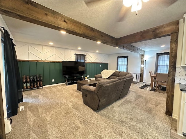 12913 E 41st St S, Independence, MO 64055 - living room featuring light colored carpet, a decorative wall, beam ceiling, ceiling fan, and recessed lighting