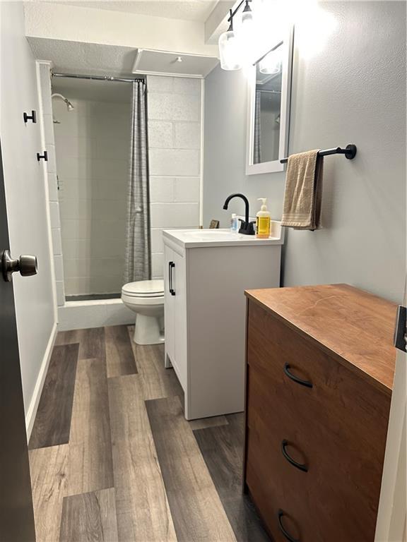 12913 E 41st St S, Independence, MO 64055 - bathroom with wood finished floors, a stall shower, and vanity