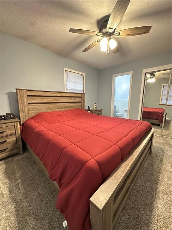 12913 E 41st St S, Independence, MO 64055 - bedroom featuring carpet floors, a textured ceiling, ceiling fan, and connected bathroom