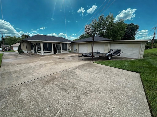 12913 E 41st St S, Independence, MO 64055 - back of property featuring a sunroom, driveway, and a yard
