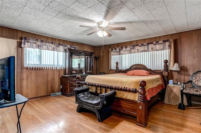 815 N 63rd St, Kansas City, KS 66102 - bedroom featuring wooden walls, light wood-style floors, and ceiling fan