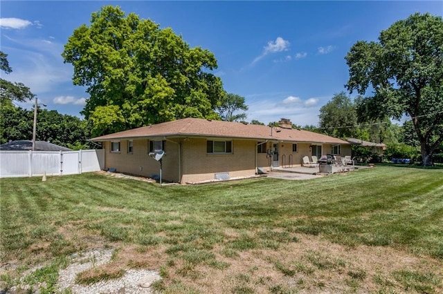 815 N 63rd St, Kansas City, KS 66102 - back of property featuring a patio area, a gate, a chimney, and brick siding