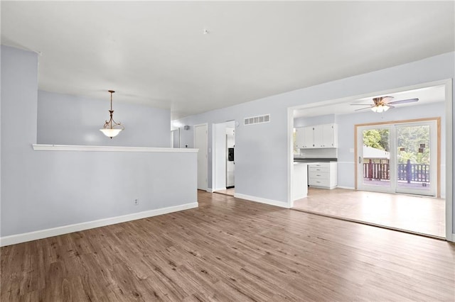 1301 Quincy St, Leavenworth, KS 66048 - unfurnished living room with light wood-style floors and a ceiling fan