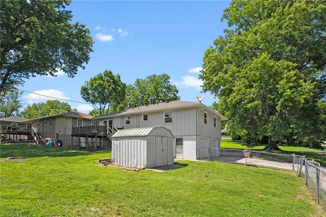 1301 Quincy St, Leavenworth, KS 66048 - back of house featuring a garage, a storage unit, a fenced backyard, driveway, and board and batten siding