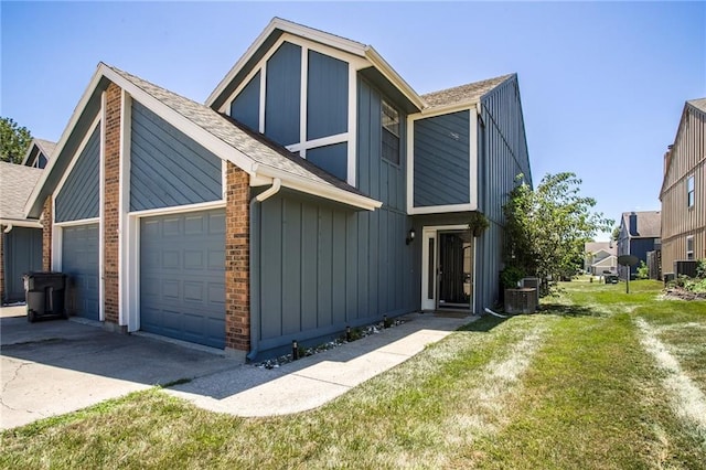512 NE Brookwood Cir Unit A, Blue Springs, MO 64014 - view of front of house with an attached garage, concrete driveway, a shingled roof, and a front yard