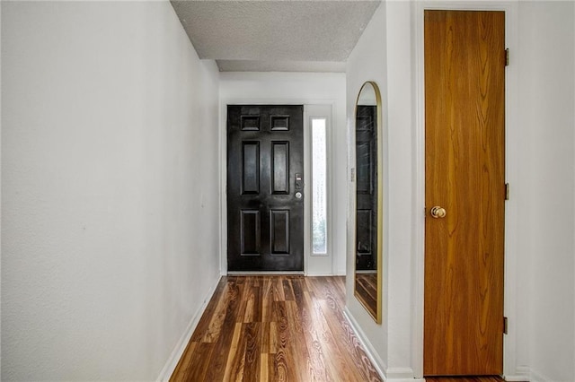 512 NE Brookwood Cir Unit A, Blue Springs, MO 64014 - entrance foyer featuring dark wood-type flooring, a textured ceiling, and plenty of natural light