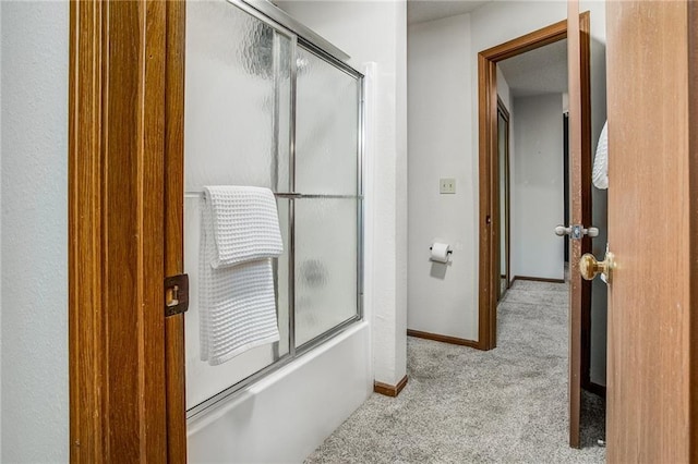 512 NE Brookwood Cir Unit A, Blue Springs, MO 64014 - bathroom featuring shower / bath combination with glass door and baseboards