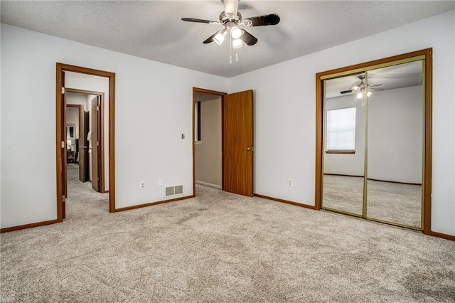 512 NE Brookwood Cir Unit A, Blue Springs, MO 64014 - unfurnished bedroom featuring carpet flooring, a closet, ceiling fan, and a textured ceiling