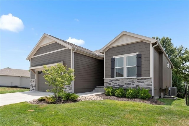 1161 SW Whitby Dr, Lees Summit, MO 64083 - view of front of home featuring an attached garage, concrete driveway, a front lawn, and stone siding