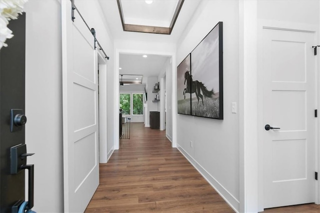 1161 SW Whitby Dr, Lees Summit, MO 64083 - corridor featuring a barn door, wood finished floors, and recessed lighting