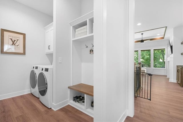 1161 SW Whitby Dr, Lees Summit, MO 64083 - laundry room with cabinet space, separate washer and dryer, light wood-style flooring, and recessed lighting