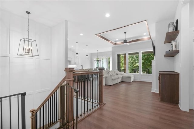 1161 SW Whitby Dr, Lees Summit, MO 64083 - hallway with an upstairs landing, wood finished floors, a chandelier, a raised ceiling, and recessed lighting