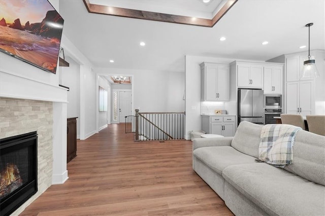 1161 SW Whitby Dr, Lees Summit, MO 64083 - living area with light wood-style floors, recessed lighting, and a fireplace