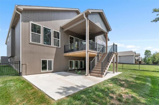 1161 SW Whitby Dr, Lees Summit, MO 64083 - rear view of house featuring a fenced backyard, a patio, a ceiling fan, and stairs
