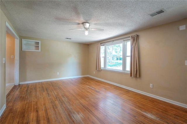 7028 Walmer St, Overland Park, KS 66204 - unfurnished room featuring ceiling fan, wood finished floors, and a textured ceiling