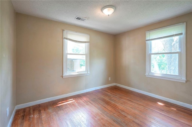 7028 Walmer St, Overland Park, KS 66204 - unfurnished room featuring wood-type flooring and a textured ceiling