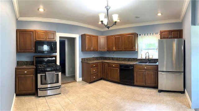 108 W Main St, Arma, KS 66712 - kitchen with black appliances, dark countertops, a chandelier, pendant lighting, and crown molding
