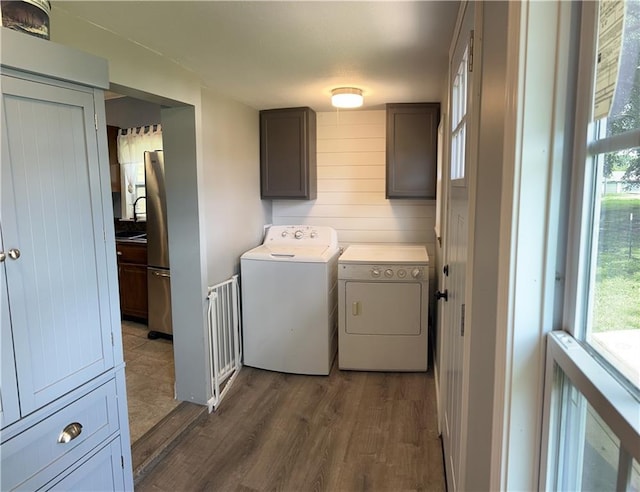 108 W Main St, Arma, KS 66712 - laundry area with washer and dryer, dark wood-style flooring, and cabinet space