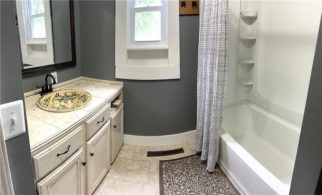 108 W Main St, Arma, KS 66712 - bathroom with vanity, shower / bath combo with shower curtain, and tile patterned flooring