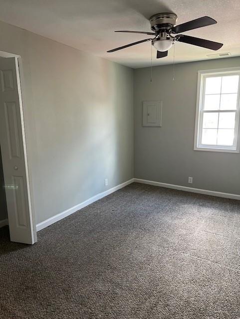 1120 S 20th St, Saint Joseph, MO 64507 - empty room with ceiling fan and dark carpet