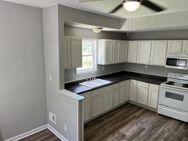 1120 S 20th St, Saint Joseph, MO 64507 - kitchen with stainless steel microwave, electric stove, dark countertops, dark wood finished floors, and ceiling fan