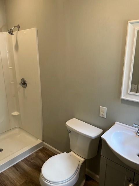 1120 S 20th St, Saint Joseph, MO 64507 - bathroom featuring wood finished floors, a shower stall, and vanity
