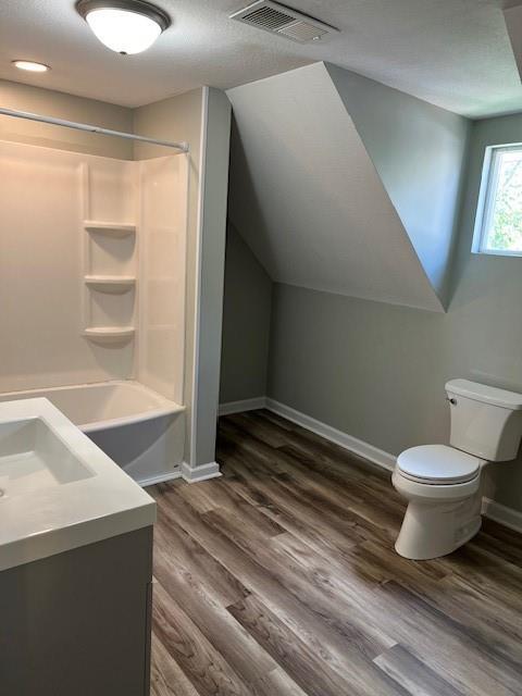 1120 S 20th St, Saint Joseph, MO 64507 - bathroom featuring vanity, bathing tub / shower combination, and wood finished floors