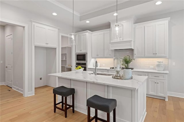 8164 Roundtree St, Lenexa, KS 66220 - kitchen featuring appliances with stainless steel finishes, light wood-style flooring, white cabinets, recessed lighting, and backsplash