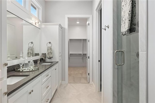8164 Roundtree St, Lenexa, KS 66220 - full bath featuring double vanity, a stall shower, a walk in closet, and tile patterned floors