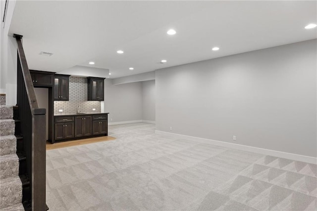 8164 Roundtree St, Lenexa, KS 66220 - finished below grade area with light carpet, stairway, recessed lighting, and bar