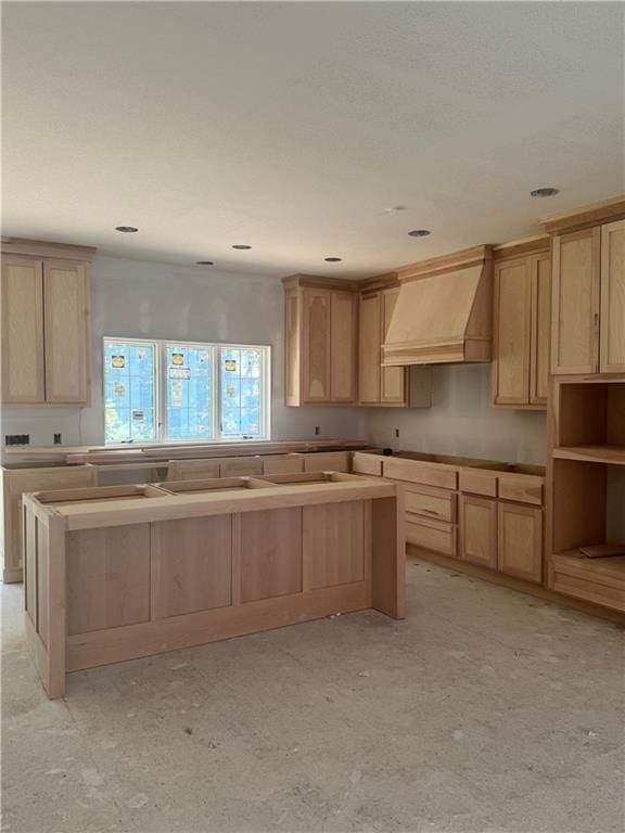 2104 W 86th Way, Leawood, KS 66206 - kitchen featuring premium range hood, light brown cabinets, and a center island