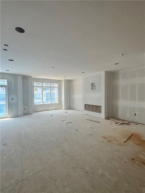 2104 W 86th Way, Leawood, KS 66206 - unfurnished living room with a textured ceiling and a fireplace