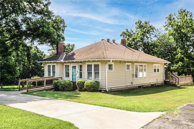 1401 E Mechanic Ave, Independence, MO 64050 - view of front facade with a chimney, a front lawn, and a deck