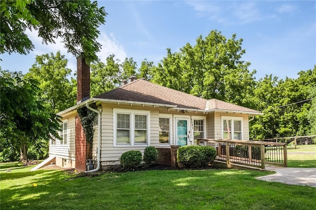 1401 E Mechanic Ave, Independence, MO 64050 - bungalow-style home featuring a chimney, a front yard, and a wooden deck