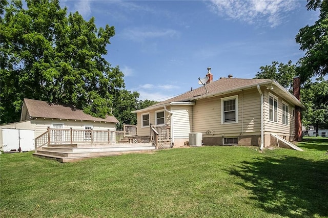 1401 E Mechanic Ave, Independence, MO 64050 - rear view of property featuring a chimney, a deck, a lawn, and a storage shed