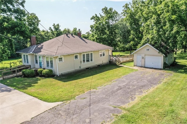 1401 E Mechanic Ave, Independence, MO 64050 - view of front of property featuring a chimney, an outdoor structure, a detached garage, and asphalt driveway