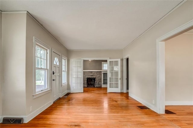 1401 E Mechanic Ave, Independence, MO 64050 - entrance foyer with light wood-style flooring, crown molding, and a fireplace