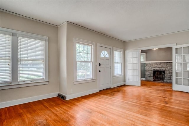 1401 E Mechanic Ave, Independence, MO 64050 - entryway with light wood-type flooring, a stone fireplace, and ornamental molding