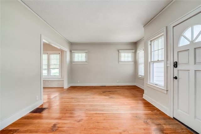 1401 E Mechanic Ave, Independence, MO 64050 - foyer featuring plenty of natural light, light wood-style floors, and ornamental molding