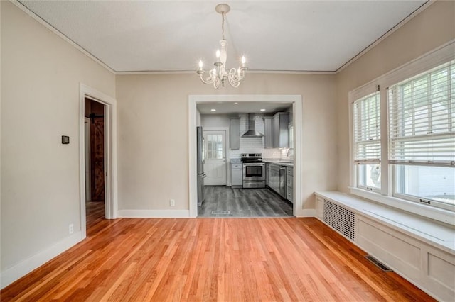 1401 E Mechanic Ave, Independence, MO 64050 - unfurnished dining area with a chandelier, light wood finished floors, and crown molding