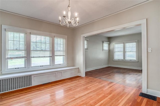1401 E Mechanic Ave, Independence, MO 64050 - spare room featuring a chandelier, wood finished floors, plenty of natural light, and ornamental molding