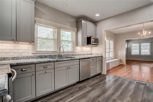 1401 E Mechanic Ave, Independence, MO 64050 - kitchen featuring stainless steel appliances, gray cabinets, a chandelier, healthy amount of natural light, and recessed lighting